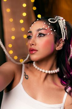 Stylish woman adorned with pearls in a glamorous setting, showcasing elegance and modern fashion.