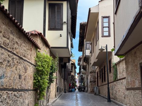 Explore the historic architecture of a narrow street in Kaleici, Antalya, Türkiye.