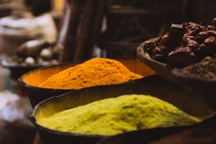 Colorful spices on display in a traditional market setting, emphasizing vibrant cultures.