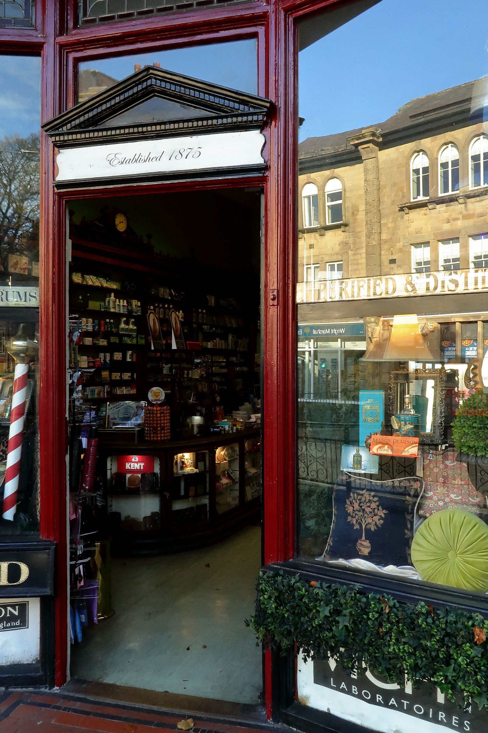 A traditional UK shopfront with vintage wares in the window