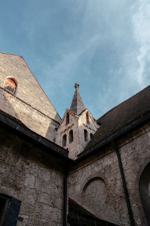 Free A stunning Gothic church tower under a bright blue sky, showcasing medieval architecture. Stock Photo