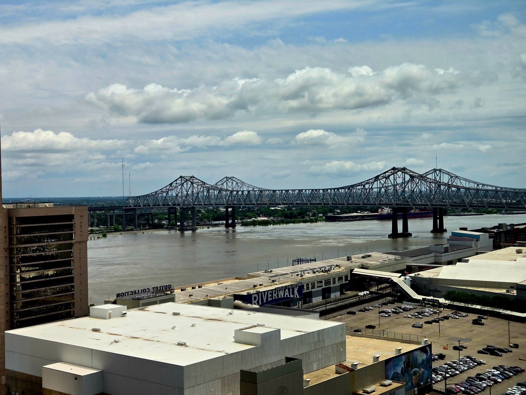 Stunning urban view of Mississippi River bridge from downtown area with cloudy sky.