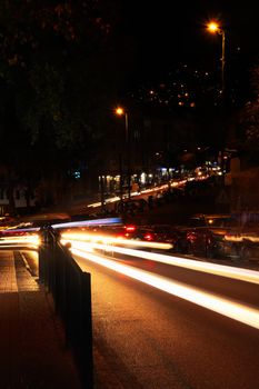 Captivating view of city street at night with stunning light trails.