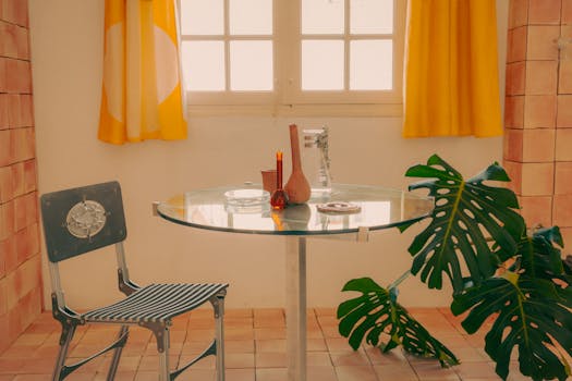 A cozy vintage-style room featuring a glass table, chair, and Monstera plant.