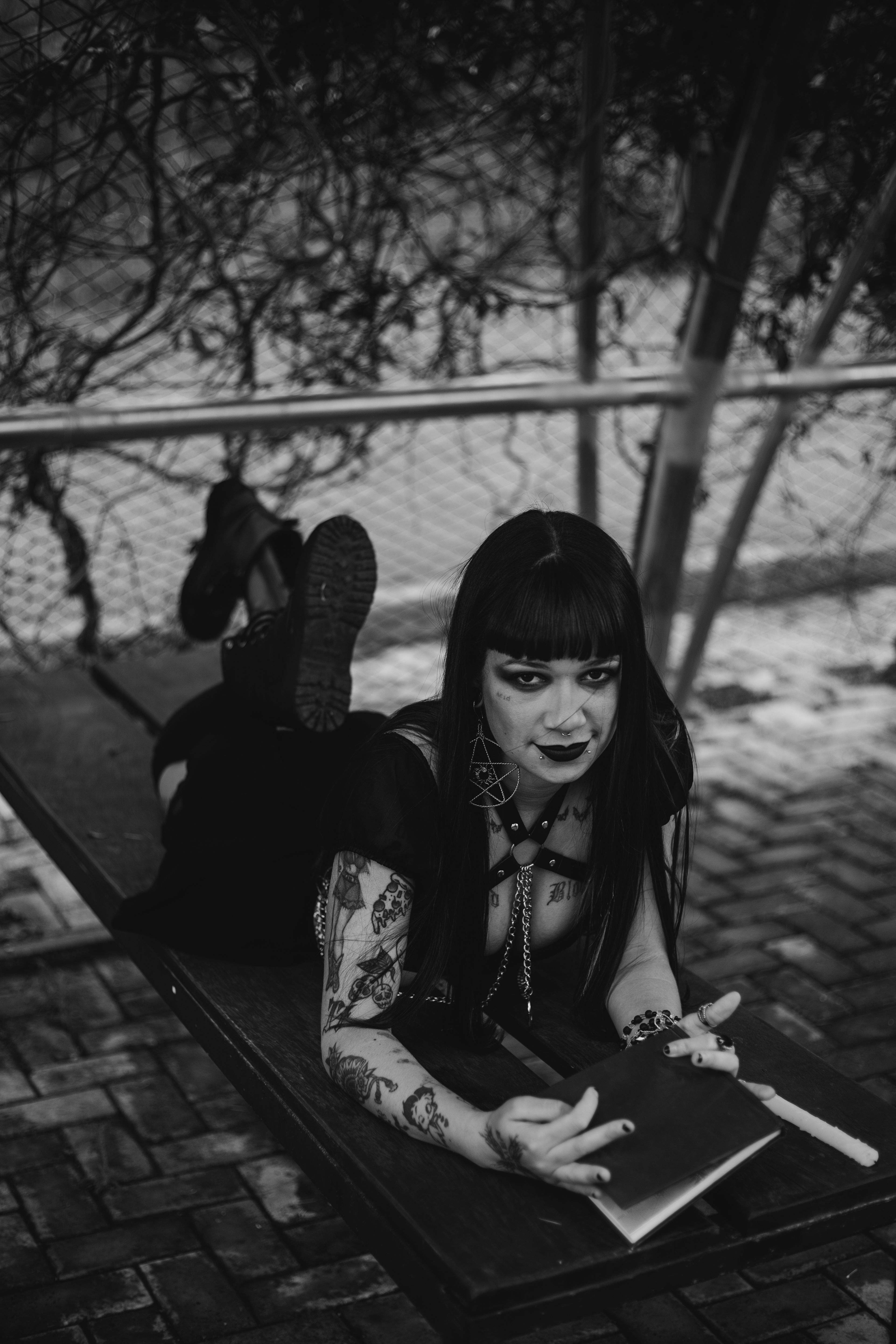 Gothic Woman Reading Outdoors in Black and White · Free Stock Photo
