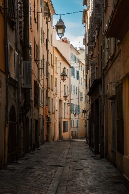 A scenic European alleyway with rustic buildings and atmospheric lighting, ideal for travel imagery.