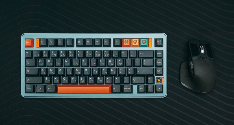 Top-down view of a vibrant mechanical keyboard with matching ergonomic mouse on a dark surface.