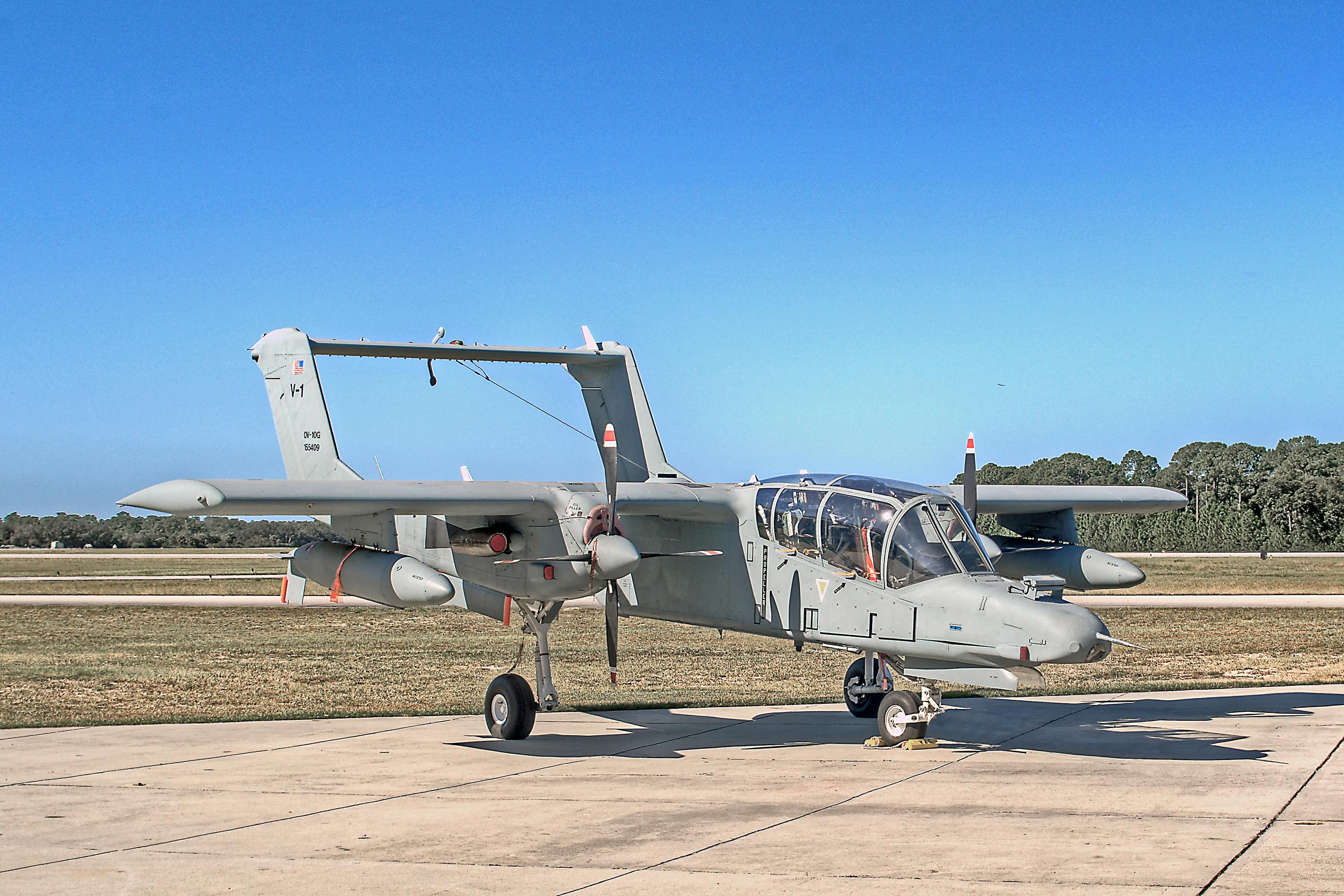 OV-10 Bronco military aircraft on a clear day at a Florida airfield.