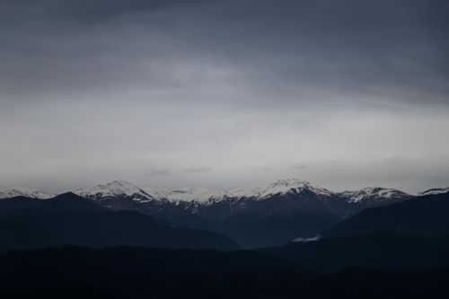 Free Dramatic view of snow-capped mountains under a moody sky in Telavi, Georgia. Stock Photo