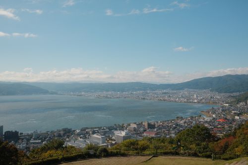 Free Breathtaking aerial view of Lake Suwa and surrounding cityscape in Nagano, Japan on a clear day. Stock Photo