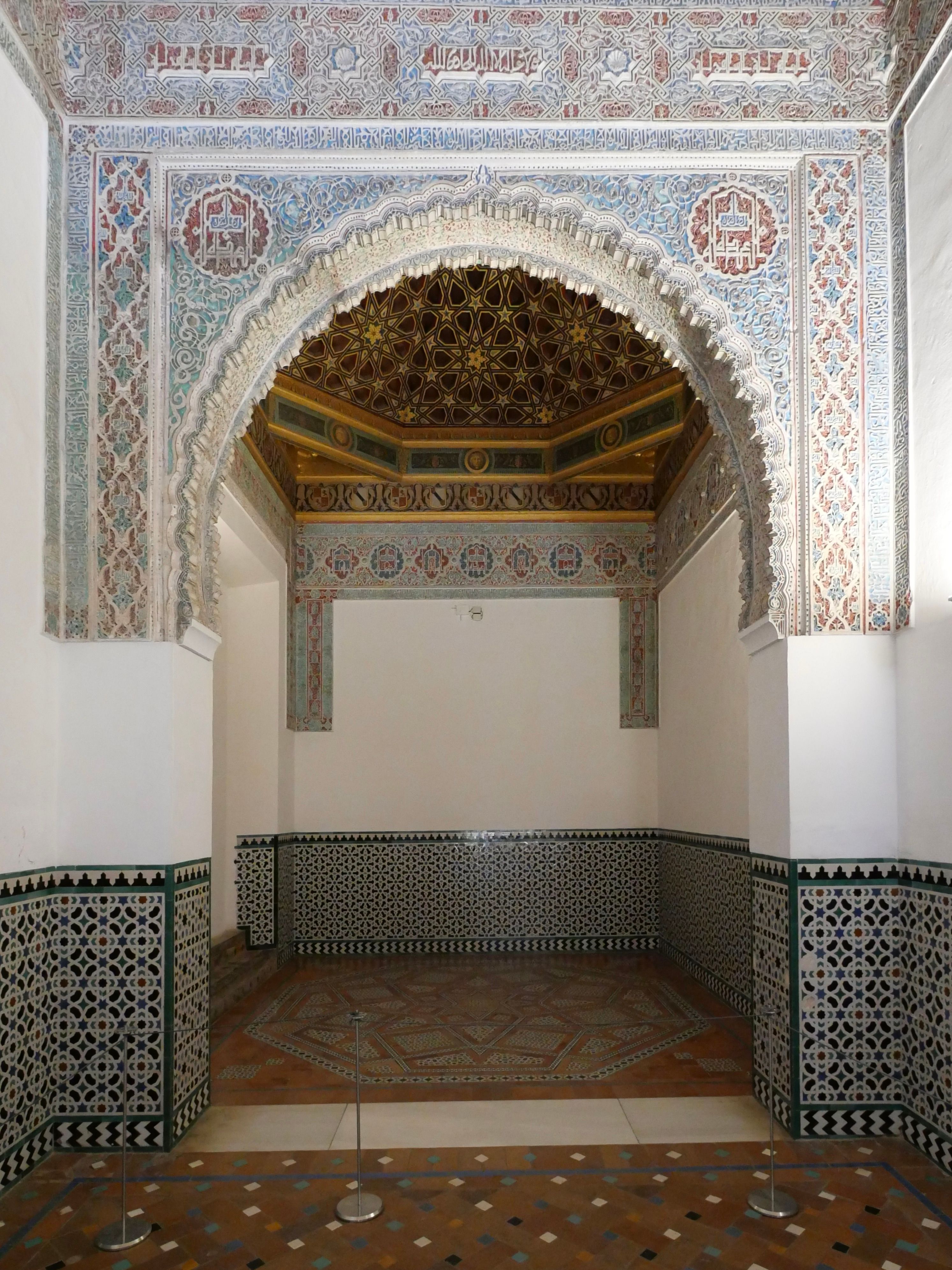 Detailed Moorish architecture with ornate archway in the Alcázar of Seville, Spain.