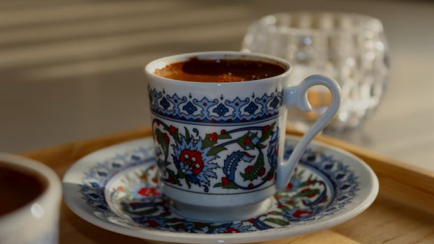 Ornate Turkish coffee cup with intricate floral patterns, perfect for cultural or culinary themes.
