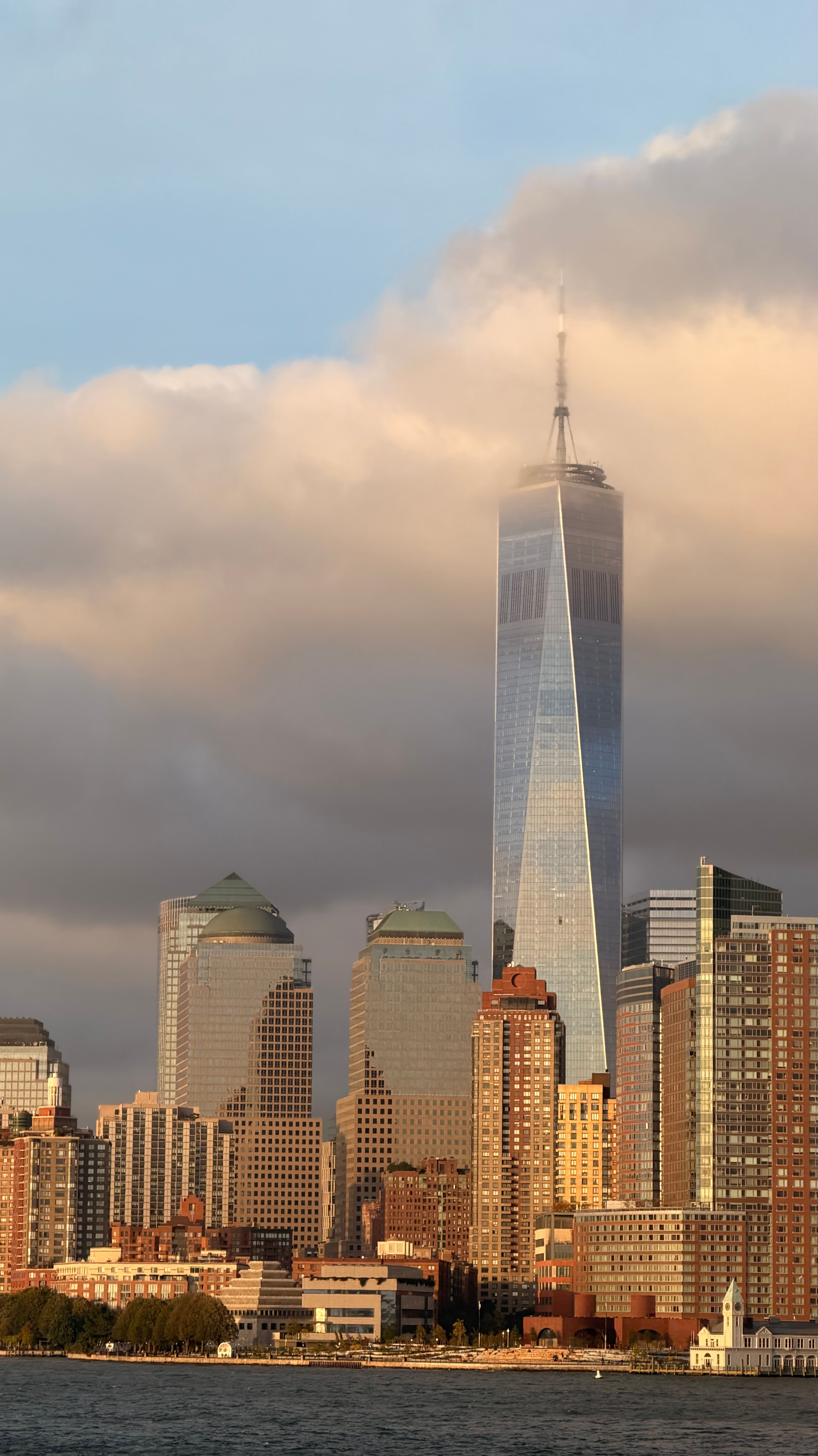 A breathtaking view of One World Trade Center against a dramatic sky in Manhattan.