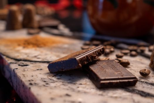 Delicious chocolate piece and coffee beans on a marble surface, creating a warm, inviting scene.