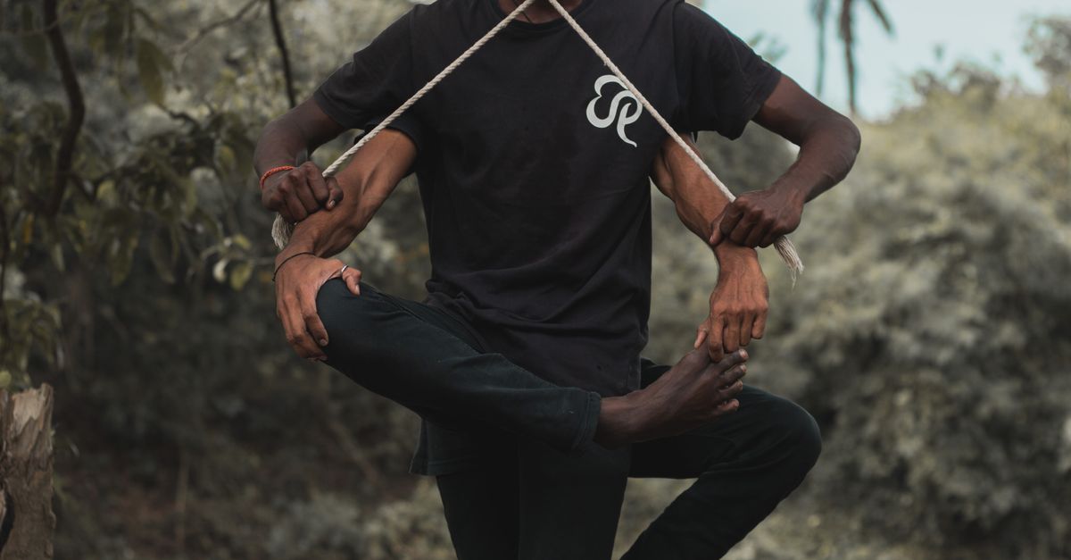 Men Balancing Men Balancing With Strings Near Body of Water · Free Stock Photo