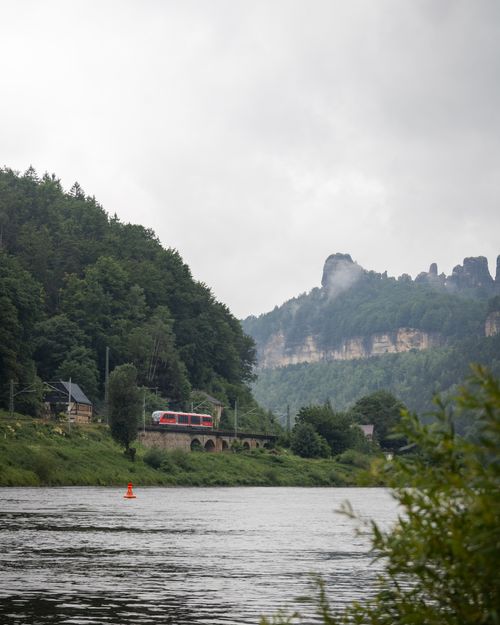 Free A picturesque train travels by the Elbe River in Saxon Switzerland, Germany Stock Photo