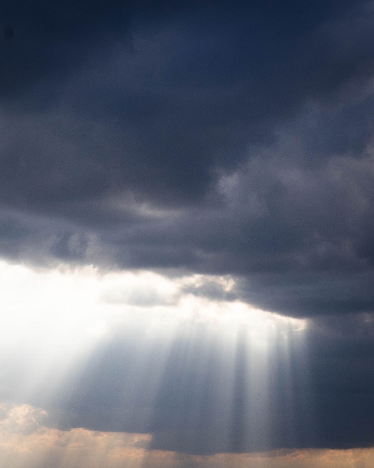 Majestic Sunbeams Breaking Through Clouds · Free Stock Photo