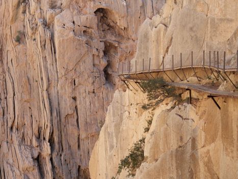 Thrilling view of Caminito del Rey walkway along steep rock walls in Spain.