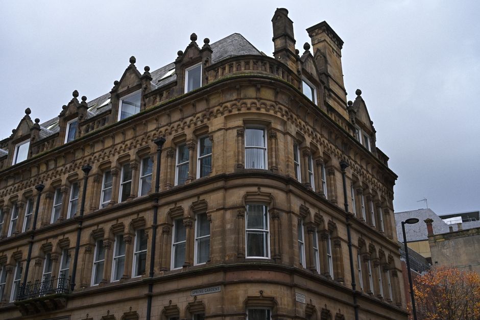 Victorian-era building facade with ornate design against overcast sky, showcasing classic architecture.