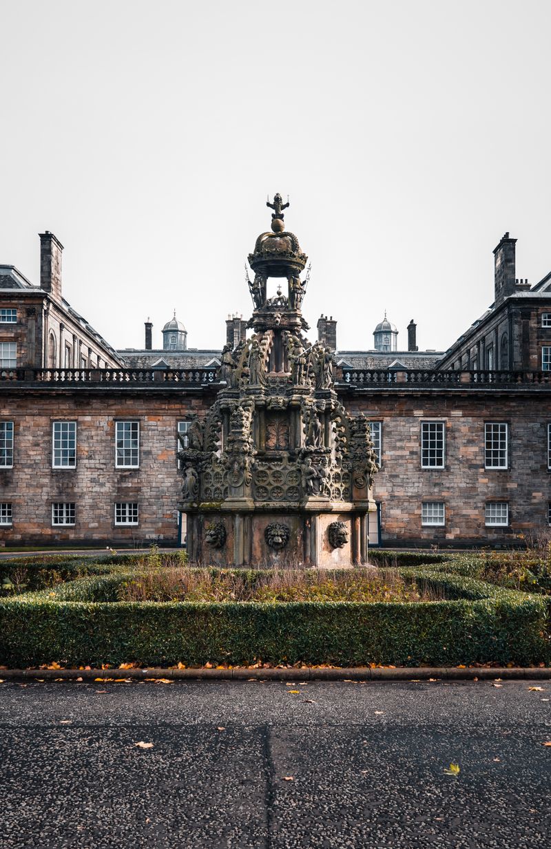 Palace of Holyroodhouse with its ornate fountain in Edinburgh