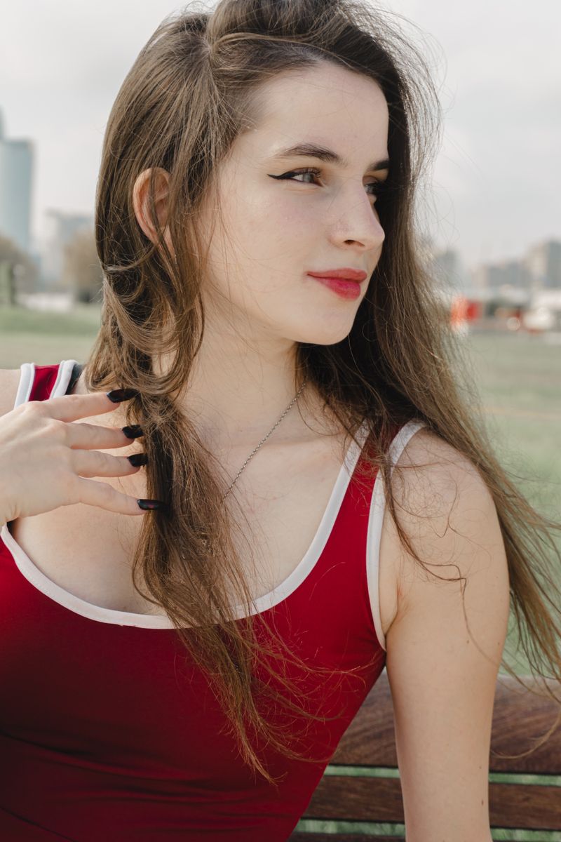 Young Woman in Red Top Posing Outdoors · Free Stock Photo