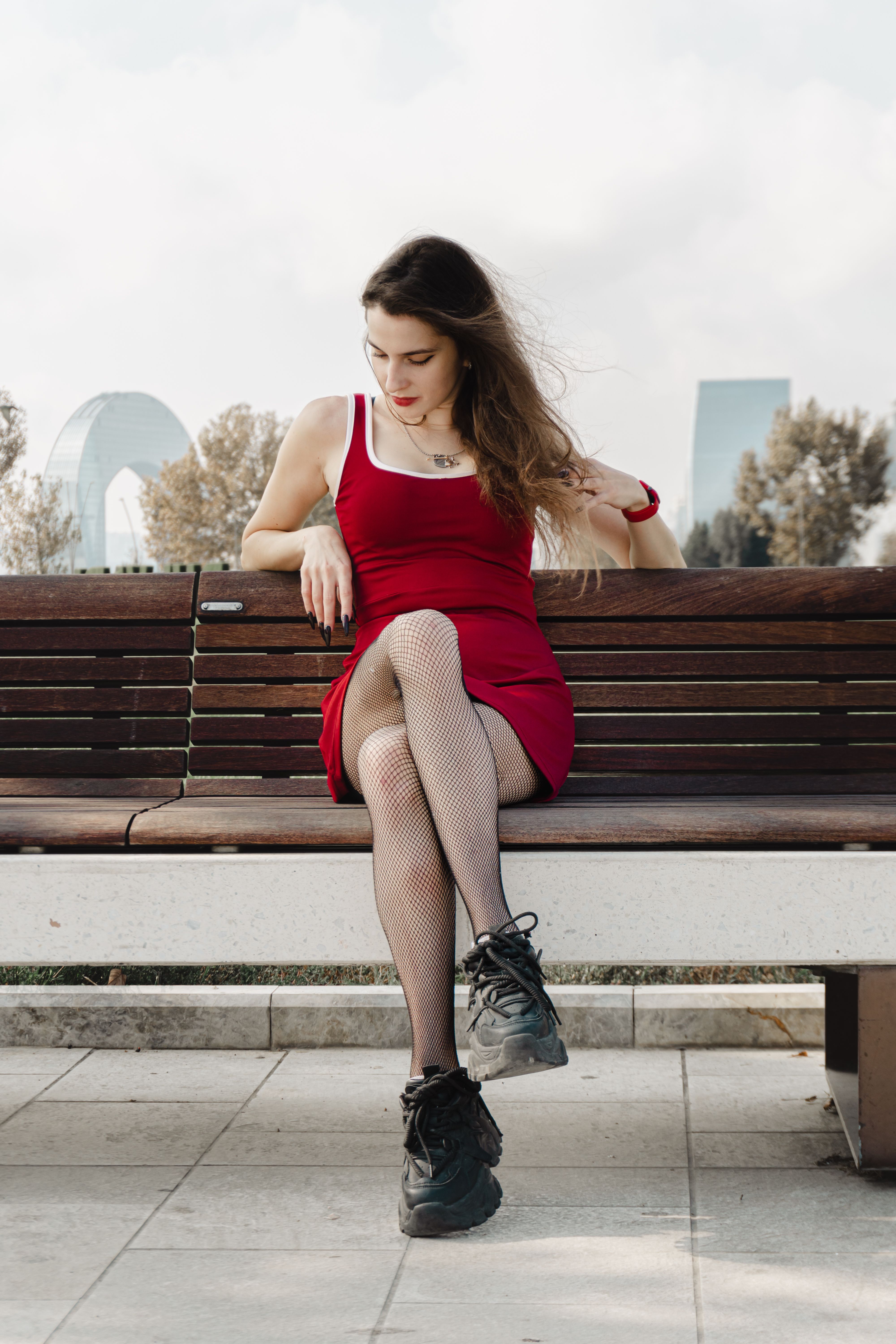 Woman Sitting on Park Bench in Red Dress · Free Stock Photo