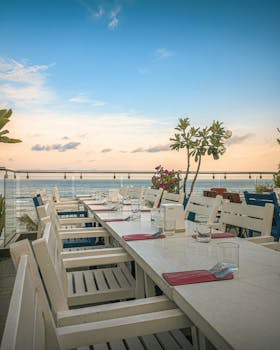 Experience luxury at an outdoor rooftop restaurant in Malé, Maldives, during sunset.