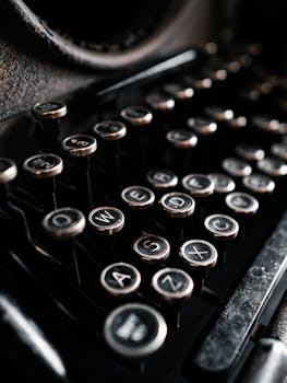 Detailed close-up of an antique typewriter showcasing its retro keys and nostalgic design.