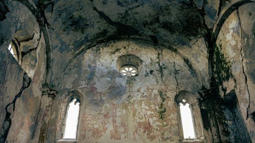 Free Interior of an old, weathered church with cracked walls and arches. Stock Photo