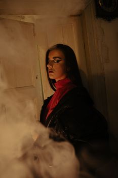 A mysterious woman in dramatic lighting with smoke effects, creating a moody atmosphere.
