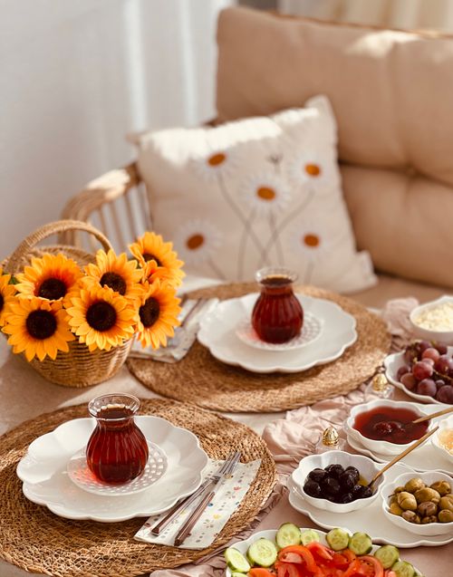 Free Cozy indoor tea setting with sunflowers and a variety of snacks for a delightful afternoon gathering. Stock Photo