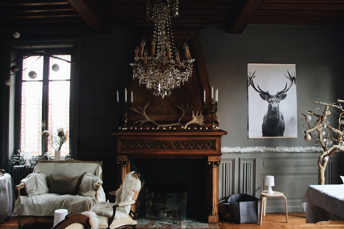 chandelier hanging over a wooden fireplace