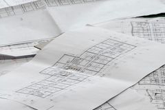Close-up of detailed architectural blueprints spread out on a desk.