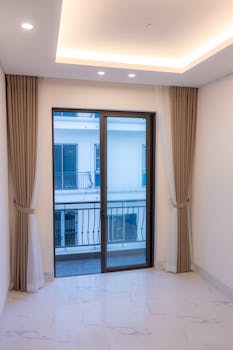 Spacious interior with large window and elegant curtains in modern style.