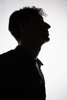 Silhouette portrait of a person with dramatic lighting and artistic style, highlighting strong profile.