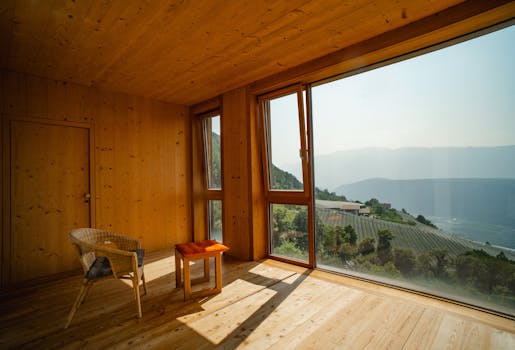 Spacious wooden interior with panoramic window view in South Tyrol, Italy.
