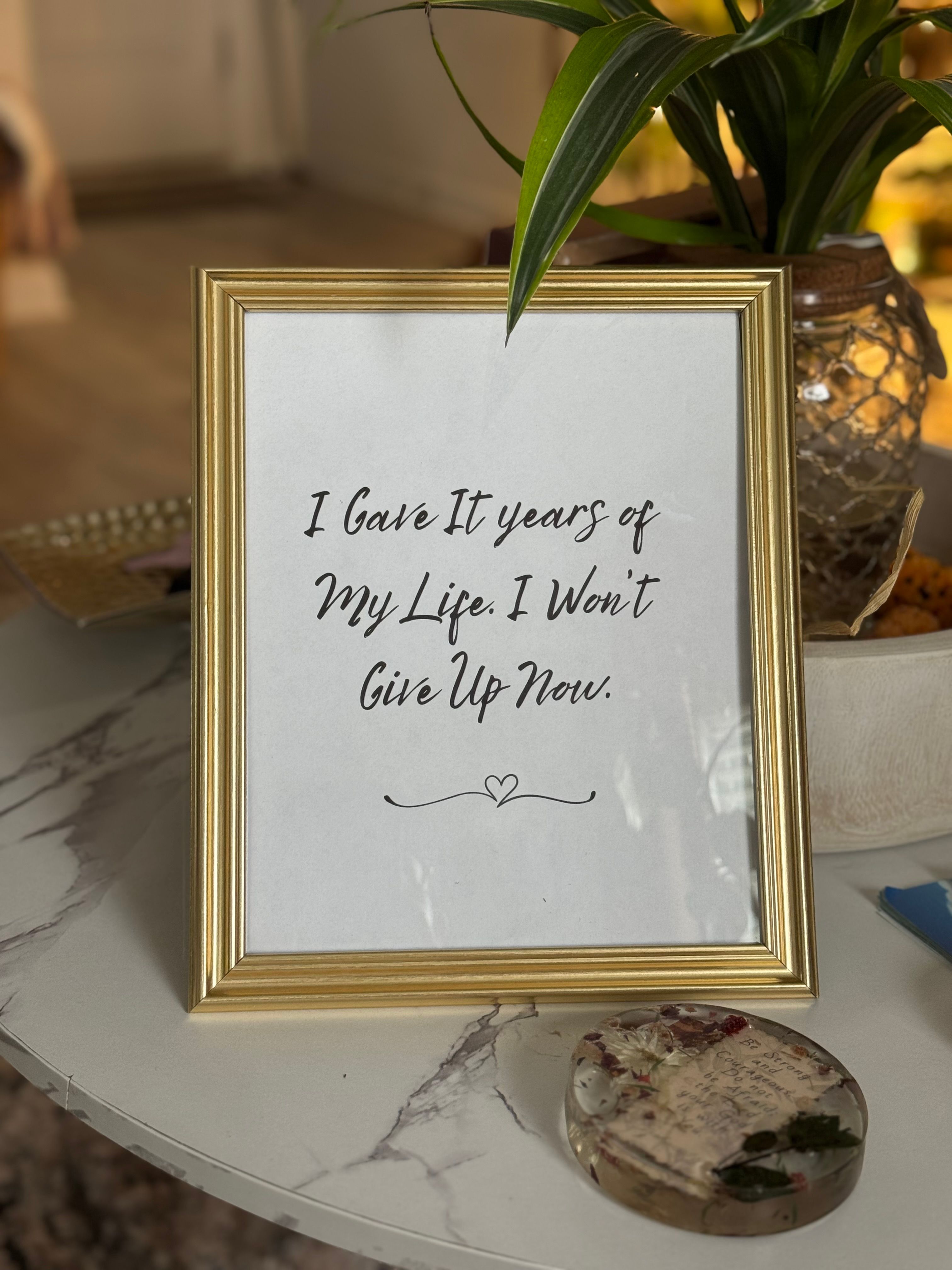 Motivational Quote in Gold Frame on Table · Free Stock Photo