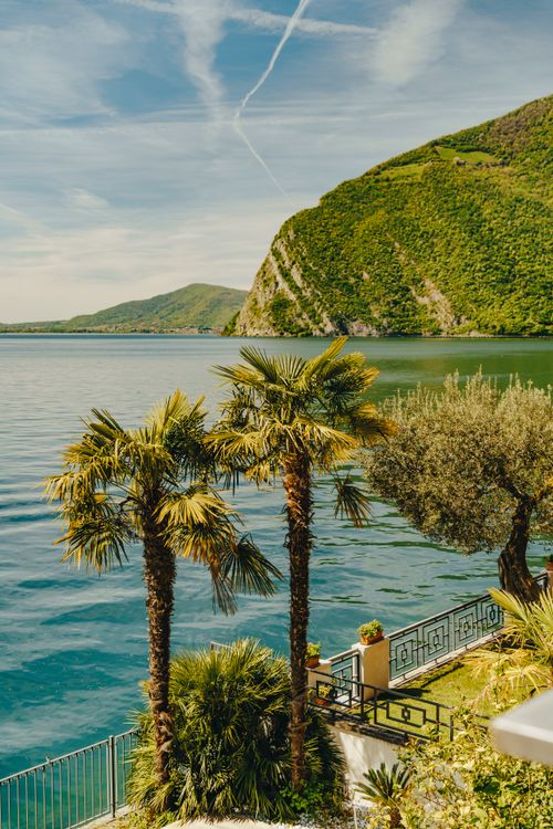 Free Beautiful landscape of Lake Iseo in Lombardy, Italy, featuring vibrant greenery and calm waters. Stock Photo