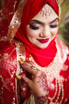 A captivating portrait of a bride in stunning red traditional attire and intricate henna.