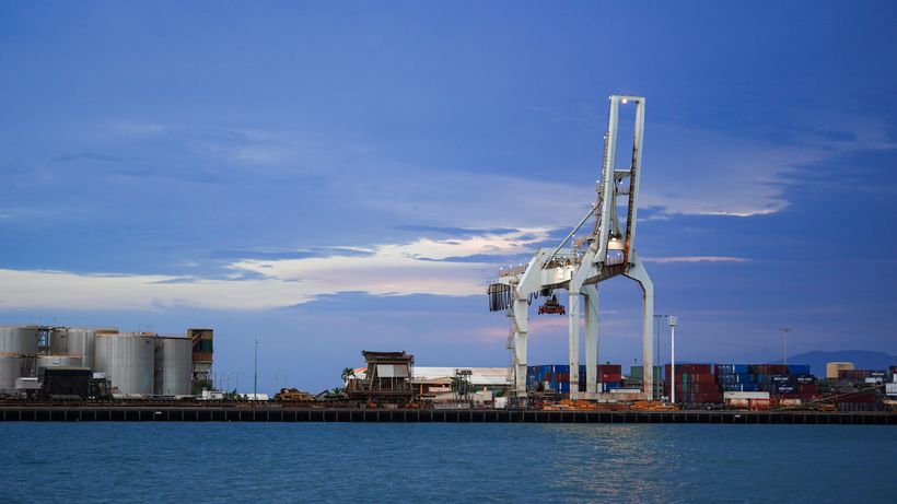 A container crane at the Delmar port terminal at twilight — photo by Paul Pulimoottil on Pexels