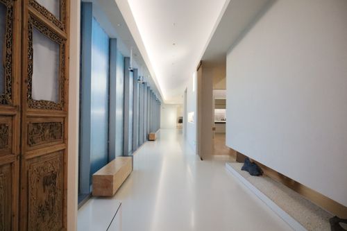Free Sleek modern hallway with wooden accents and minimalist architecture. Stock Photo