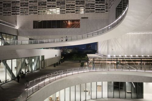 Free Sleek modern architecture captured at night with elegant curved walkways. Stock Photo