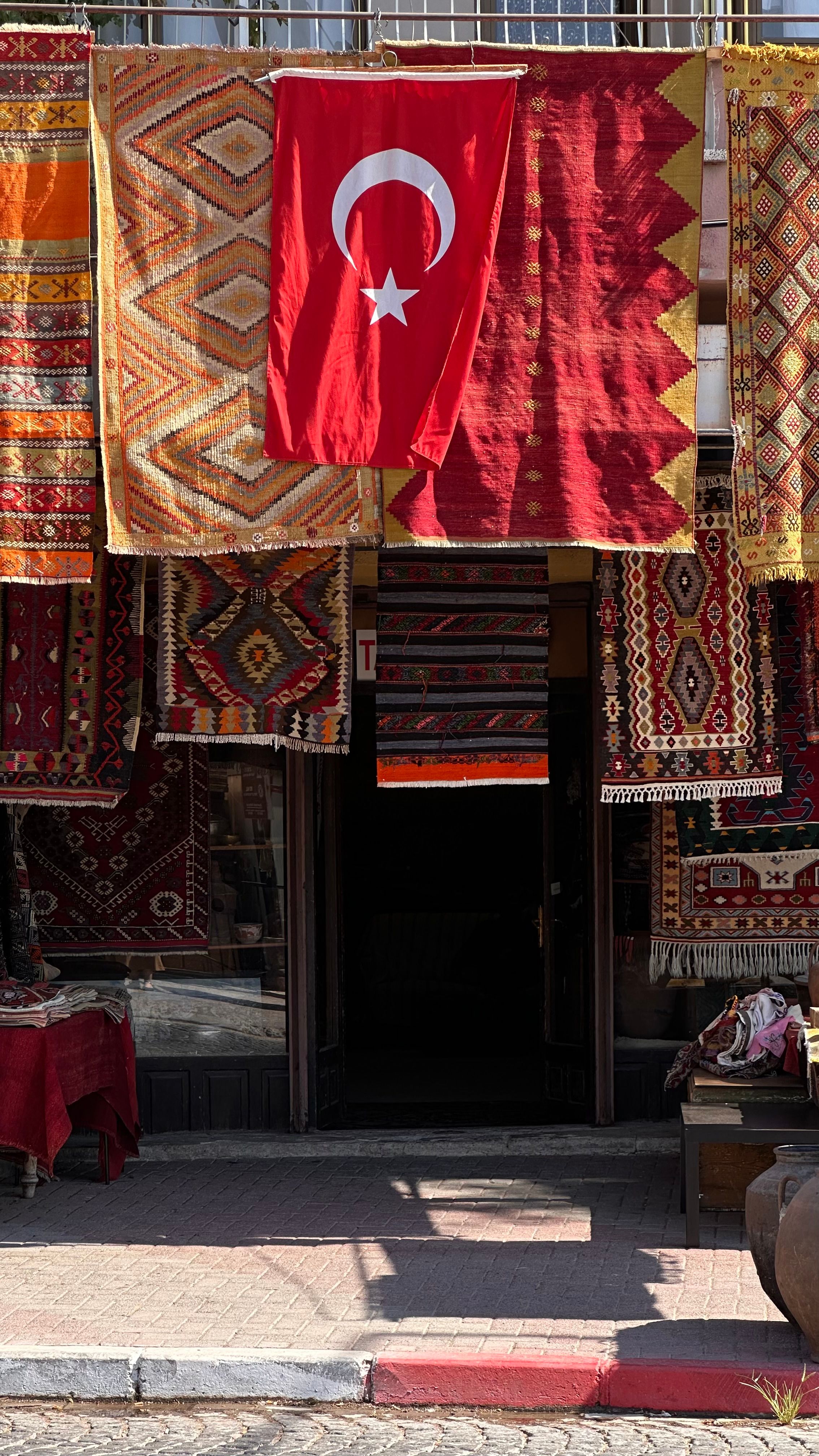 Traditional Turkish Rugs and Flag in Market Display · Free Stock Photo