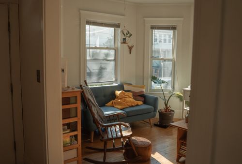 Free Bright and inviting living room with natural light highlighting modern decor and plants. Stock Photo