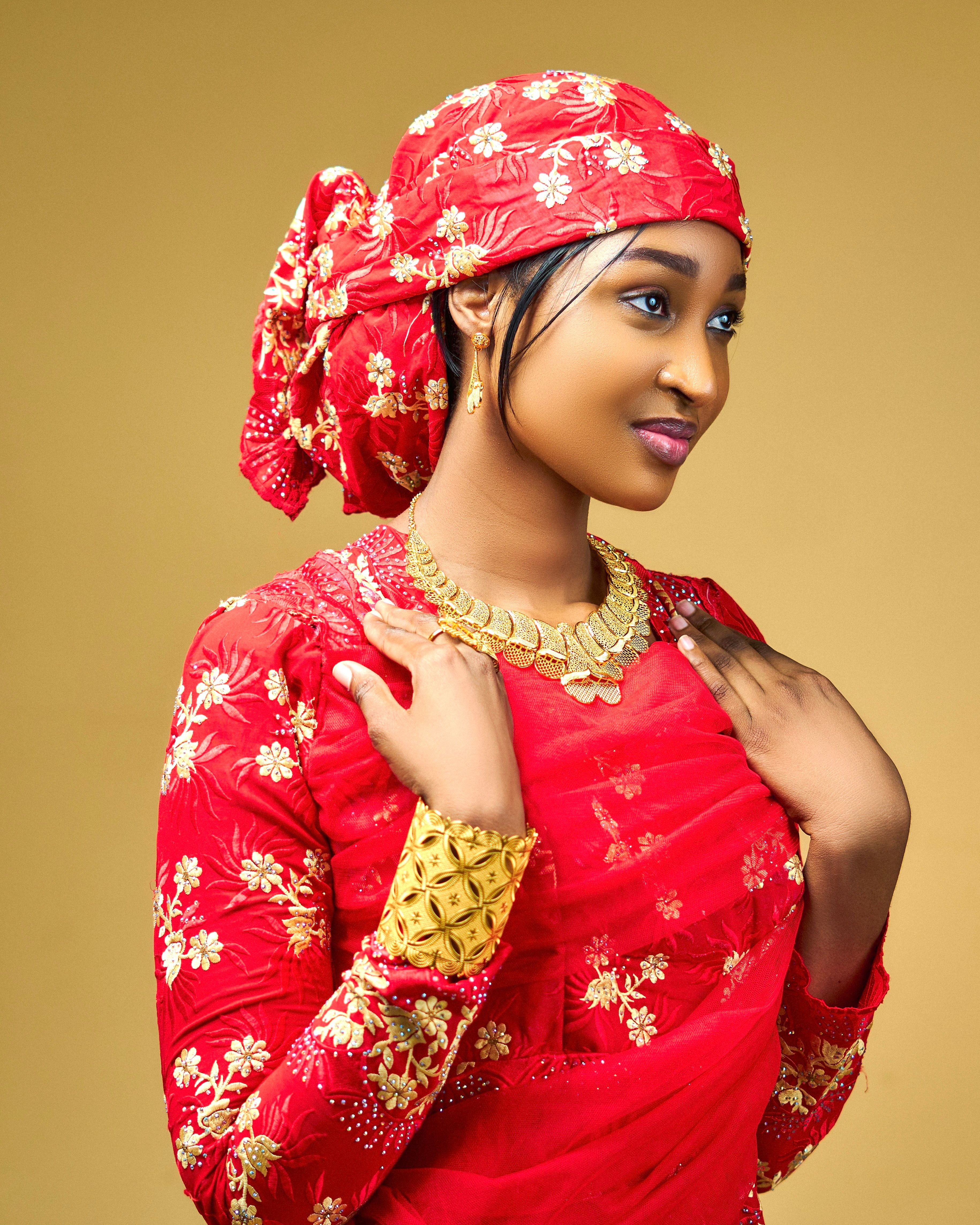 Elegant Woman in Traditional Red Attire with Jewelry · Free Stock Photo