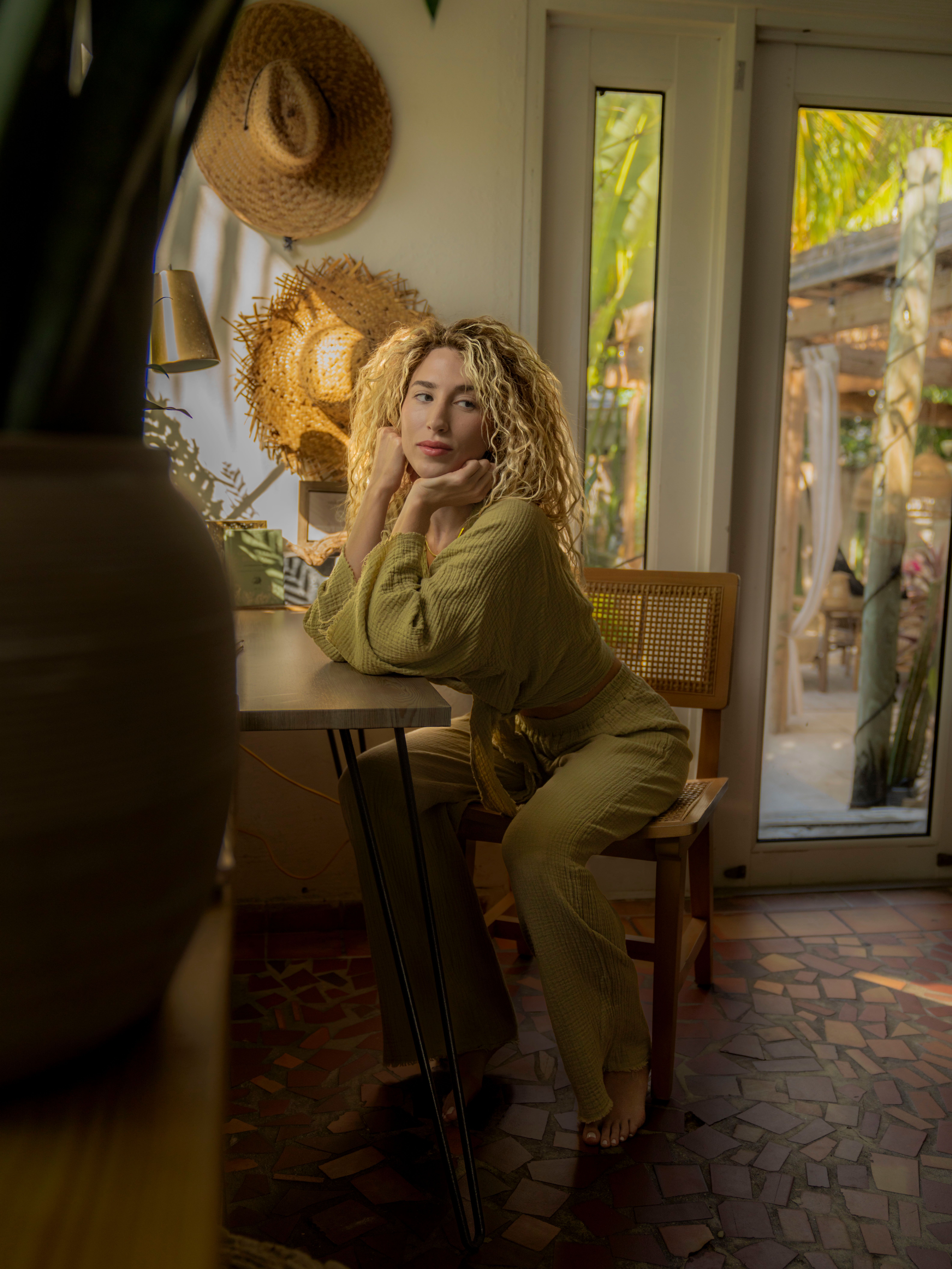 Stylish Woman in Cozy Indoor Space with Natural Light · Free Stock Photo