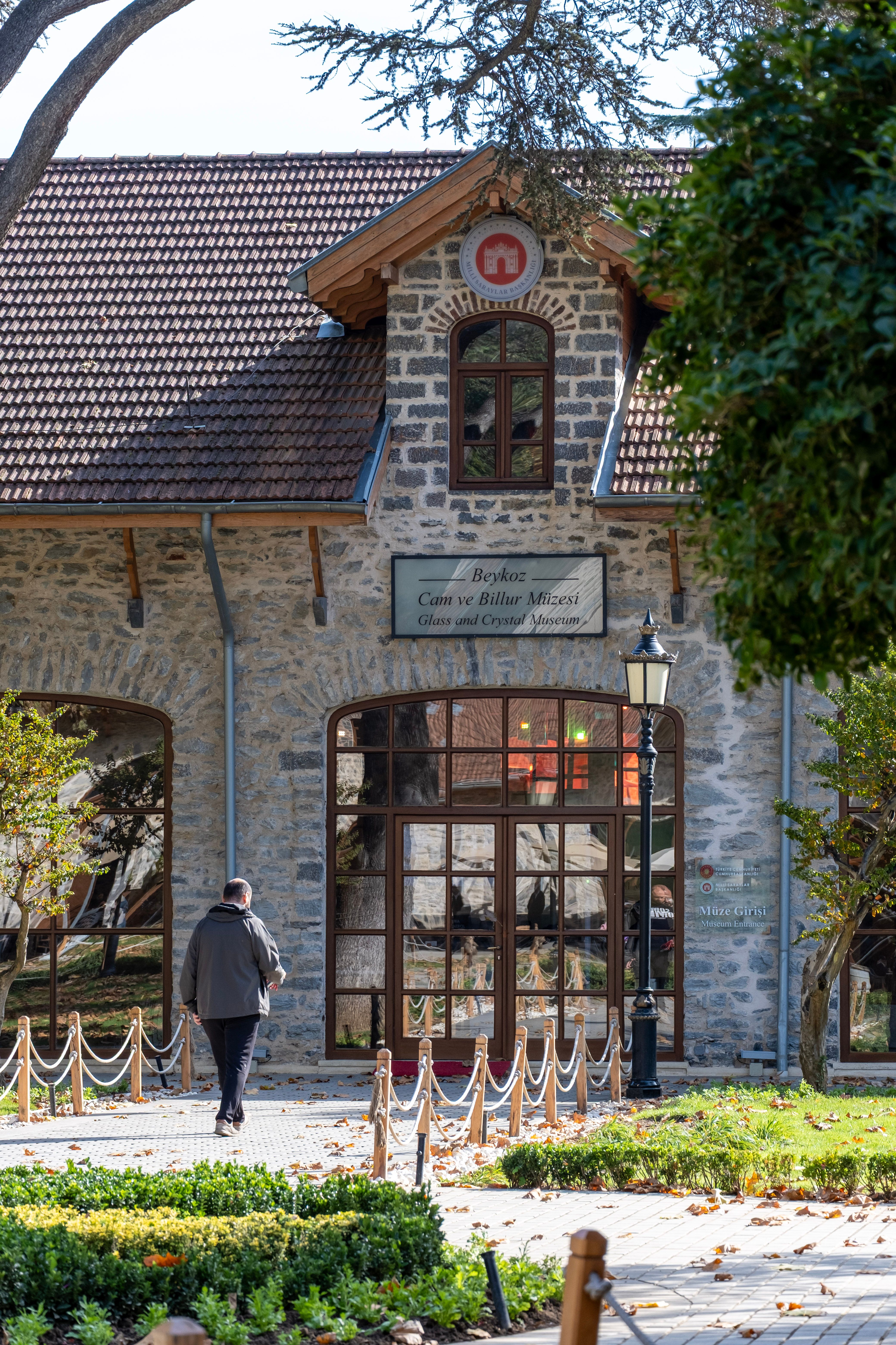 Front view of Beykoz Glass and Crystal Museum in İstanbul with a man walking.