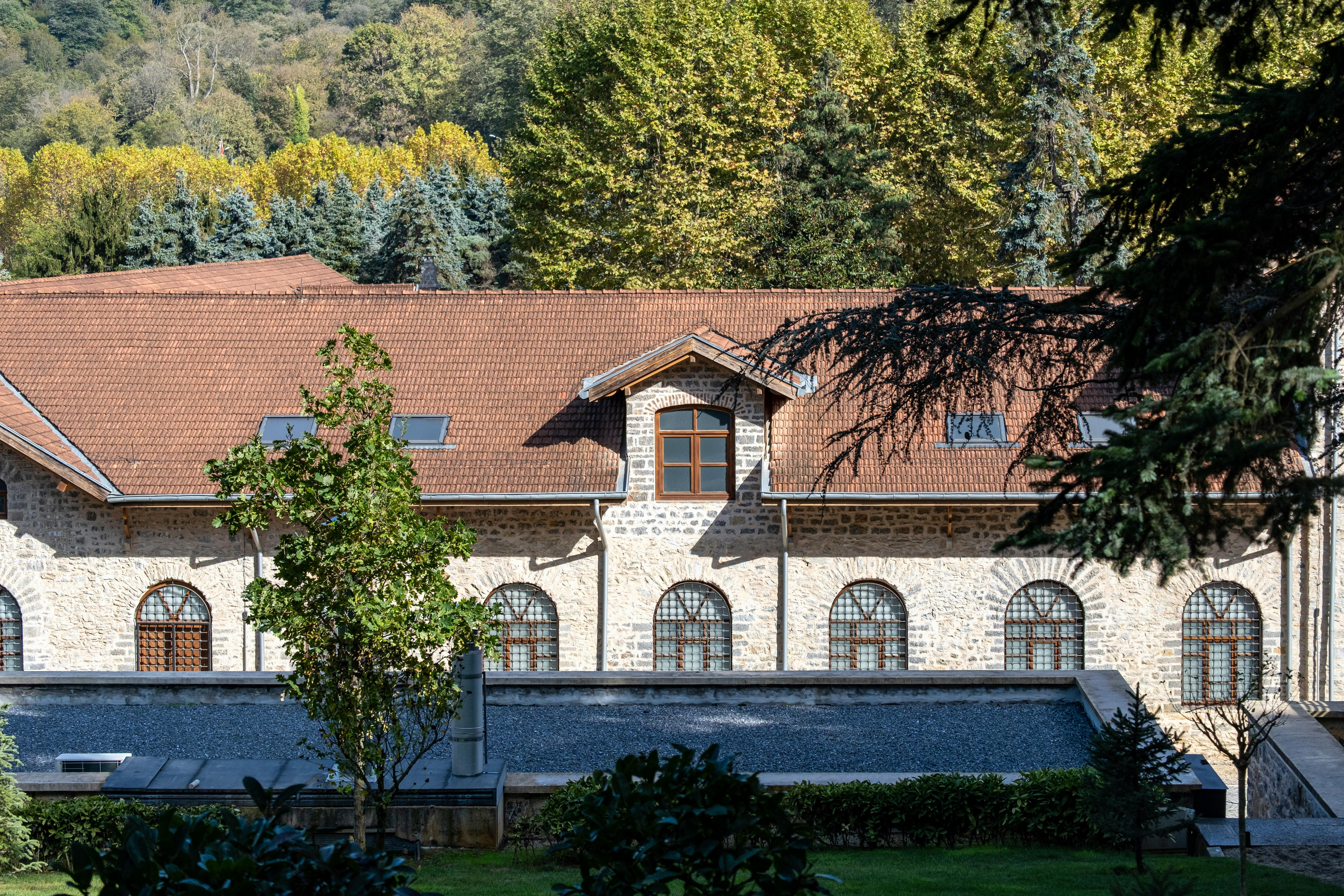 Explore a beautiful historic building nestled in lush foliage in İstanbul, Türkiye.