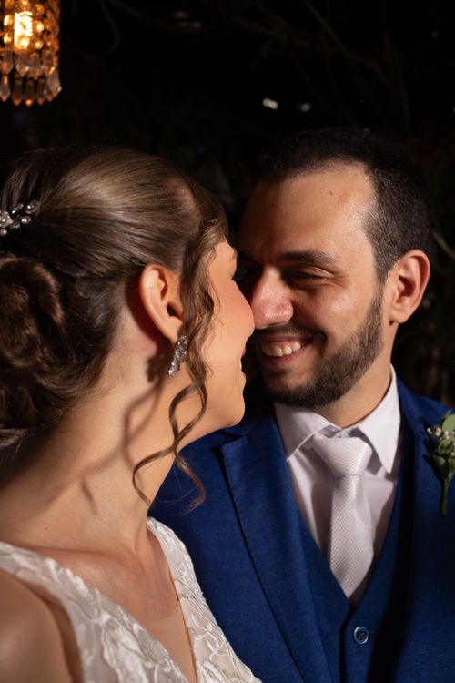 Free Close-up of a joyful couple smiling lovingly at each other on their wedding day indoors. Stock Photo
