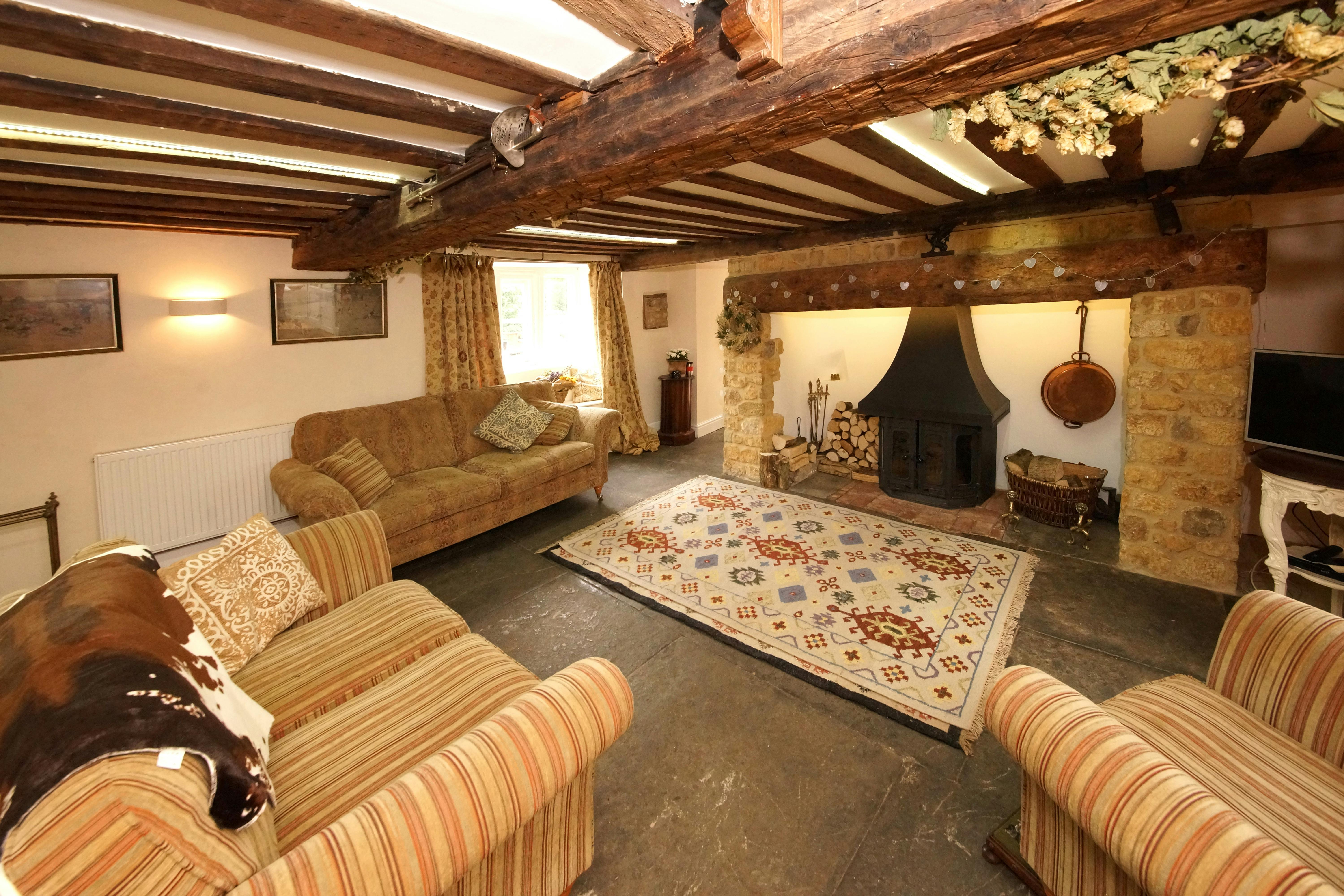 Classic Western furniture in a rustic living room setting with wooden beams and leather armchairs